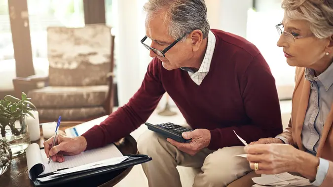 old senior retired couple calculating finances