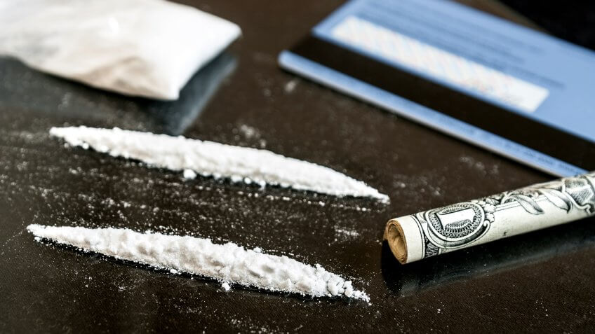 rolled up US dollar bill and cocaine