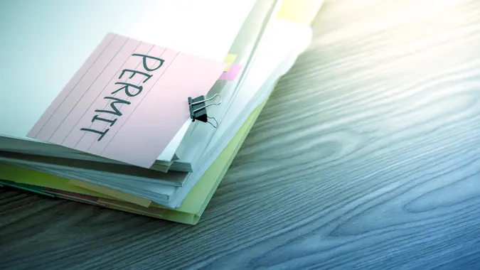 Permit; The Pile of Business Documents on the Desk.