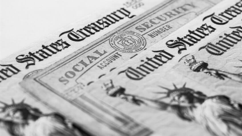 Partial view of Social Security card and US Treasury checks.