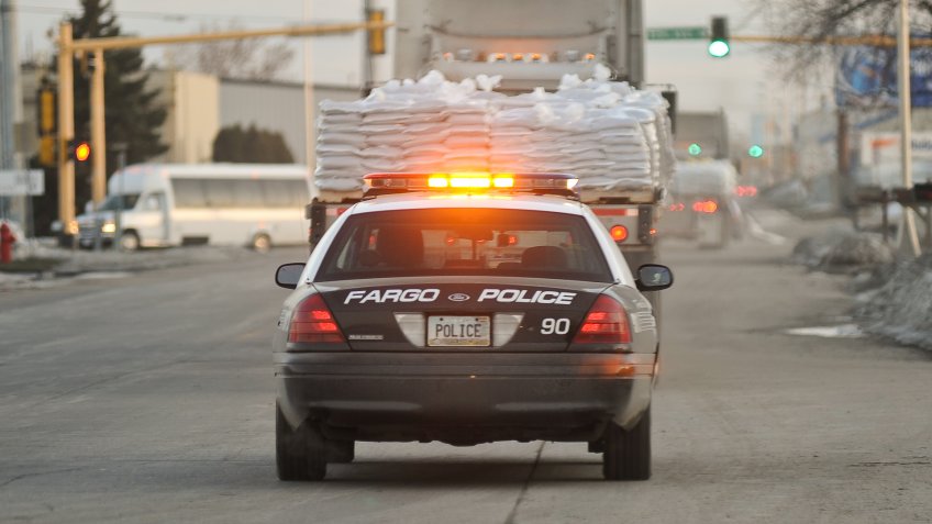 As the Red River rises to major flodd stage Fargo Police help deliever sand bags to where they are needed.