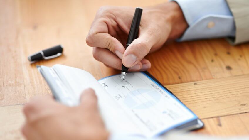 man writing a check