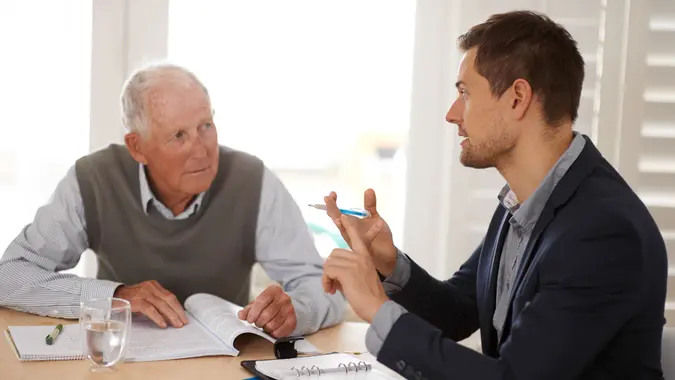 retiree discusses taxes and finances with financial advisor