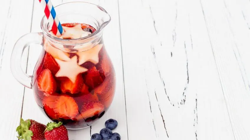6 Red, White and Blue Batch Cocktails for Under $12, White and Blue Lemonade or Sangria. Patriotic drink cocktail wit, blueberry and apple for 4th of July party, red