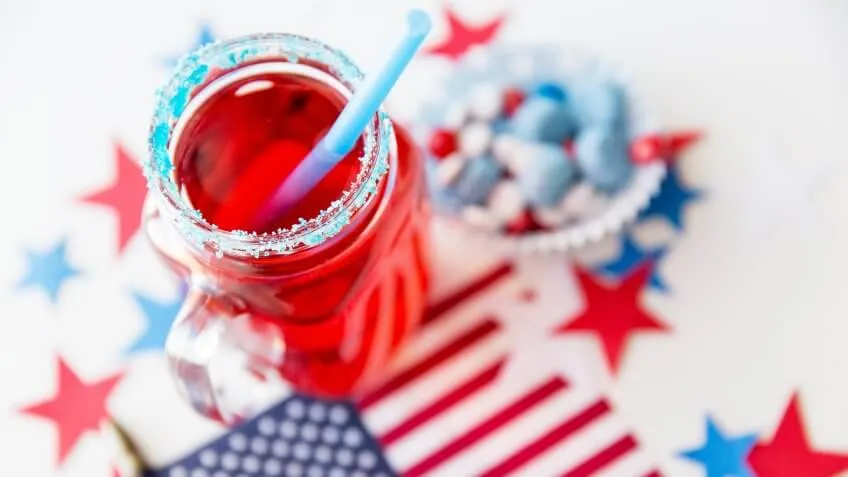 6 Red, White and Blue Batch Cocktails for Under $12, american independence day, celebration, flag and candies at 4th july party, patriotism and holidays concept - close up of juice glass