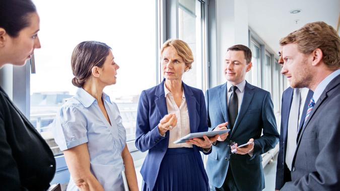 You Already Have Your 35 Highest-Earning Years Mature businesswoman sharing new business ideas with colleagues during a meeting in office.