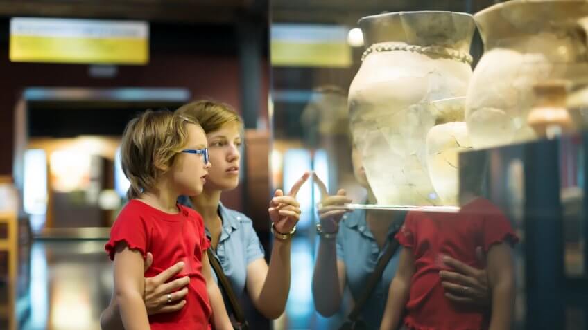 child and mother looking at museum exhibits