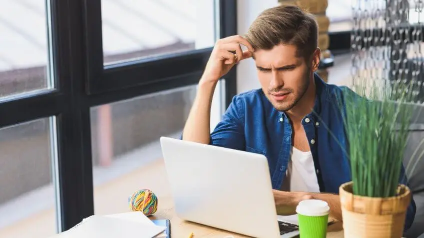 Confused-young-freelancer-in-front-of-a-laptop-shutterstock_481612996