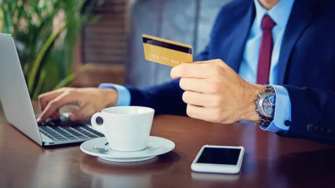 11078, Adult, Banking, Business, Business Person, Businessman, Buying, Cafeteria, Caucasian Ethnicity, Cheerful, Coffee - Drink, Communication, Connection, Corporate Business, Credit Card, Cup, Currency, Customer, E-Mail, E-commerce, Elegance, Expense, Fashion, Finance, Global Communications, Happiness, Horizontal, Internet, Laptop, Lifestyles, Luxury, Male Beauty, Males, Men, Mobile Phone, Paying, Positive Emotion, Retail, Shopping, Smart Phone, Success, Suit, Technology, Wireless Technology, man, people
