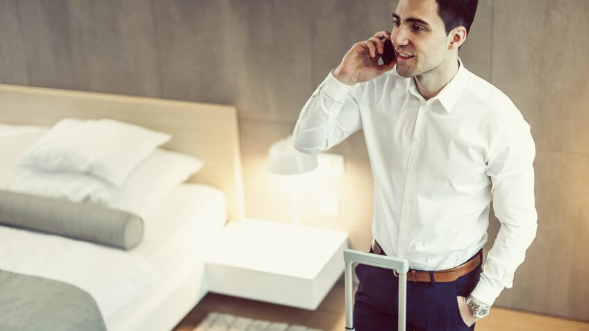 Businessman on the phone at the hotel room.