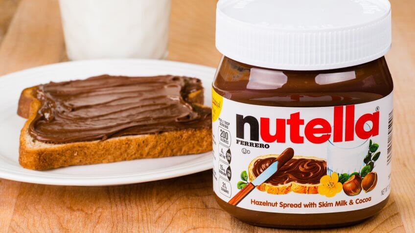 2014: Jar of Nutella, ATLANTA - APRIL 23, Things that are always cheaper at Costco, toast with Nutella spread and milk to drink.