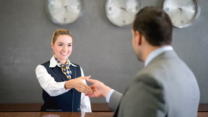 Business man handshaking manager at the hotel and doing check in - people traveling concepts.