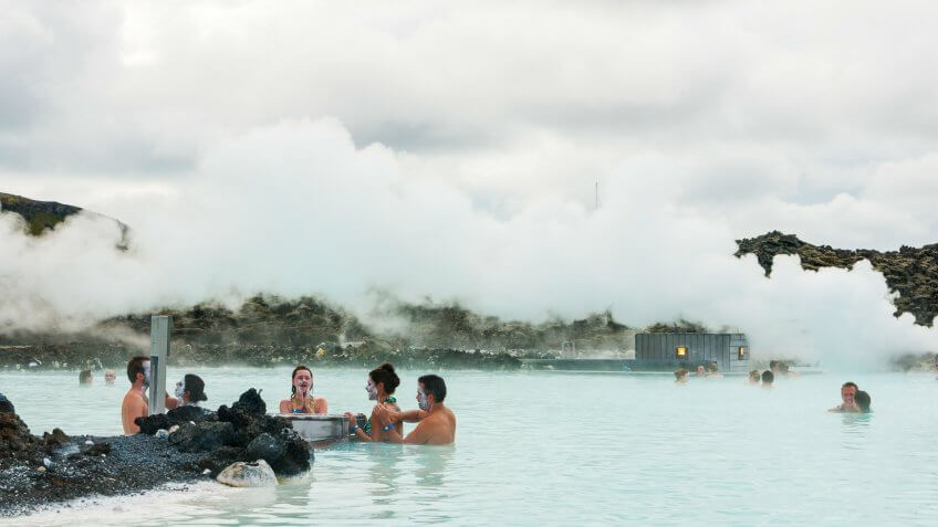 Reykjavik, Iceland - August 27, 2010: People apply silica mud to their skin while bathing in the Blue Lagoon, a geothermal spa in the south near the capitol, a popular tourist attraction.