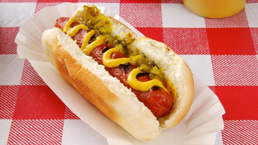 A hot dog with relish on a picnic table, Things that are always cheaper at Costco