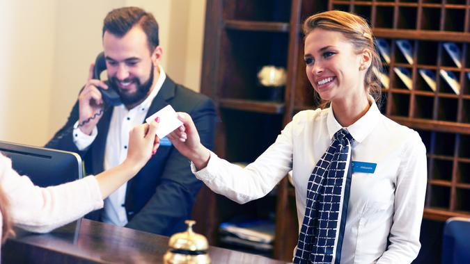 Free Hotel Upgrades That You're Missing Out On, Picture of guests getting key card in hotel