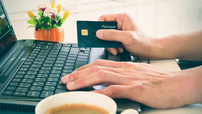 Business man holds a platinum credit card in his right hand whil, Free Hotel Upgrades That You're Missing Out On