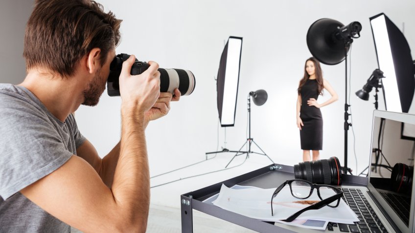 96 Money-Making Skills You Can Learn in Less Than a Year, Photographer shooting model in studio with softboxes