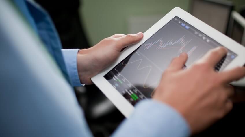 person picking stocks from tablet