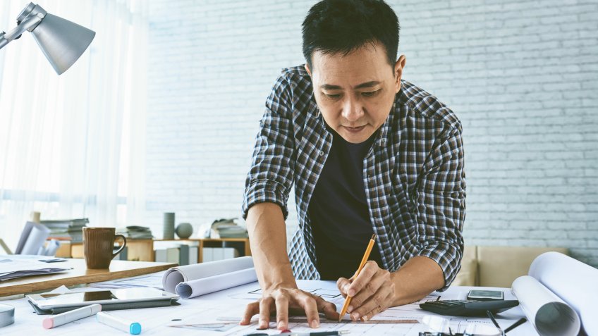 96 Money-Making Skills You Can Learn in Less Than a Year, Singaporean architect concentrated on work on blueprint