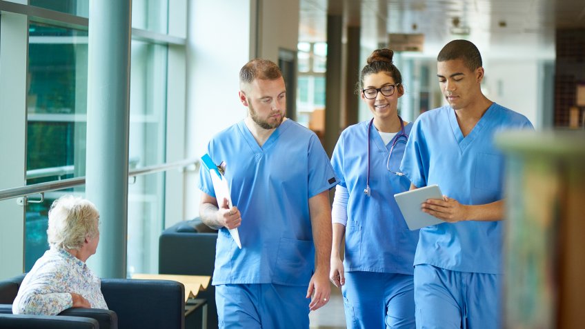 96 Money-Making Skills You Can Learn in Less Than a Year, 20-29 Years, 30-39 Years, African Descent, Candid, Clinic, Corridor, Digital Tablet, Doctor, Female Doctor, Females, Healthcare And Medicine, Hospital, Junior Doctor, Learning, Male Nurse, Males, Medical Occupation, Medical Student, Modern, Multi-Ethnic Group, Nurse, Occupation, Patient, Trainee, Training Class, UK, Uniform, Walking, Working, blue, copy space, four people, horizontal, medical record, men, student, talking, university, women