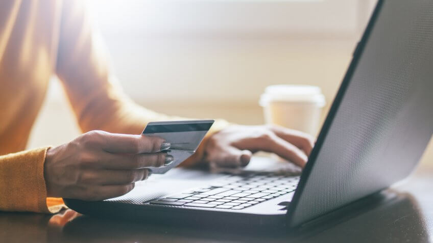 Adult, Banking, Business, Buying, Caucasian Ethnicity, Coffee Cup, Computer, Computer Keyboard, Computer Monitor, Credit Card, Drink, E-Mail, E-commerce, Equipment, Females, Finance, Human Finger, Human Hand, Internet, Laptop, Midsection, One Person, PC, Paying, People, Plastic, Selective Focus, Shopping, Take Out Food, Technology, Touching, Wireless Technology, Young Adult, close-up, retail, women