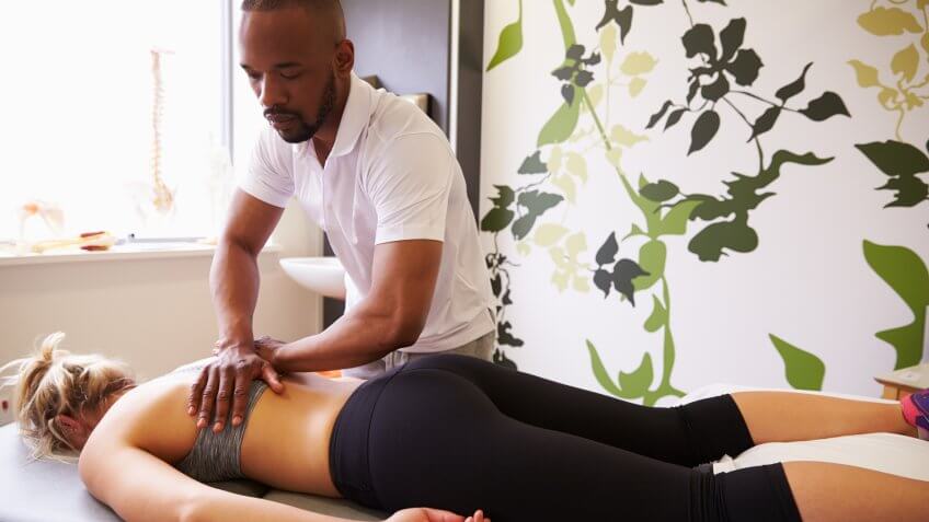 96 Money-Making Skills You Can Learn in Less Than a Year, Physiotherapist Giving Female Patient Massage In Hospital