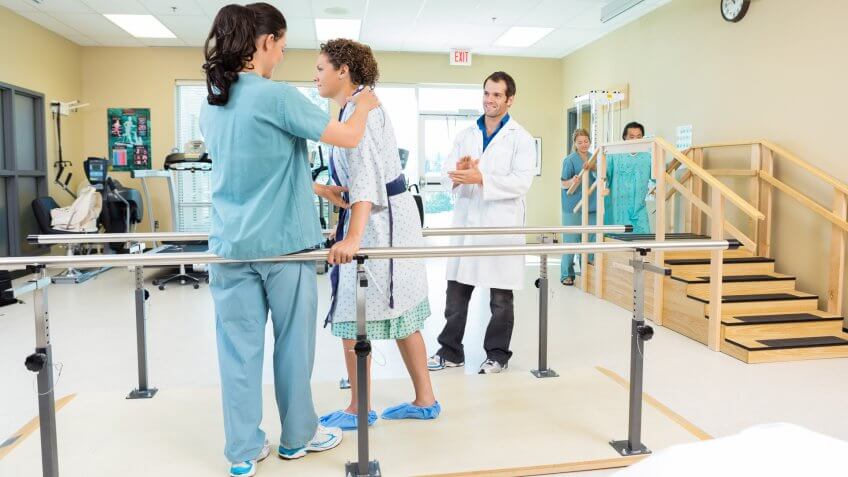 96 Money-Making Skills You Can Learn in Less Than a Year, Mid adult female patient being assisted by physical therapist wh