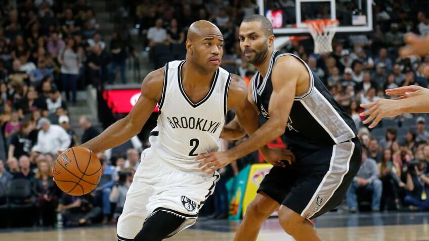 SAN ANTONIO, TX - OCTOBER 30: Jarrett Jack #2 of the Brooklyn Nets drives around Tony Parker #9 of the San Antonio Spurs at the AT&T Center on October 30, 2015 in San Antonio, Texas.