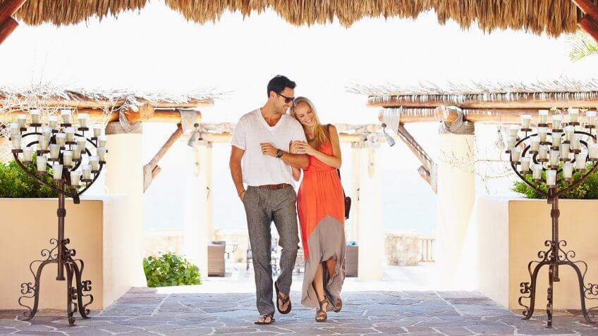Couple walking under awning outdoors.