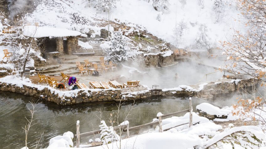 Strawberry Hot Springs surrounded by winter forest.