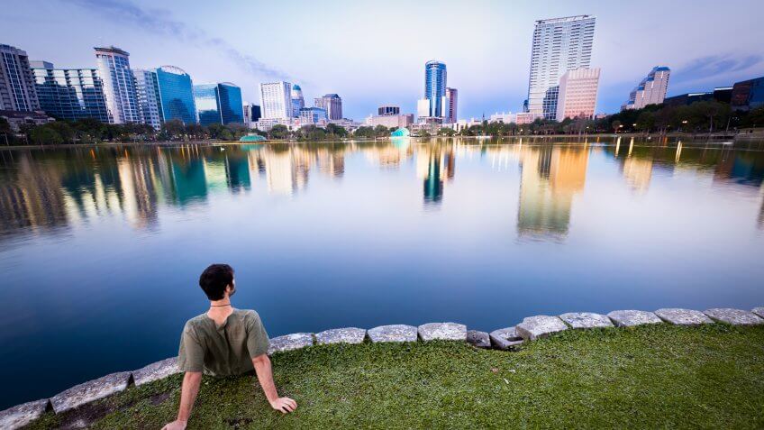 Man staring at the cityscape of Orlando, Florida, USA.