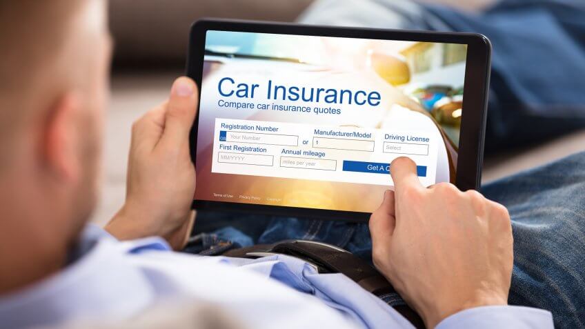 Close-up Of A Man Filling Car Insurance Form On Digital Tablet.