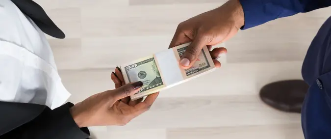 Elevated View Of Business Man And Woman Exchanging Money.