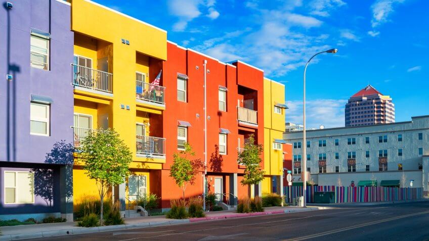 Photo of a city street with new, colorful townhouses in downtown Albuquerque, New Mexico, USA.