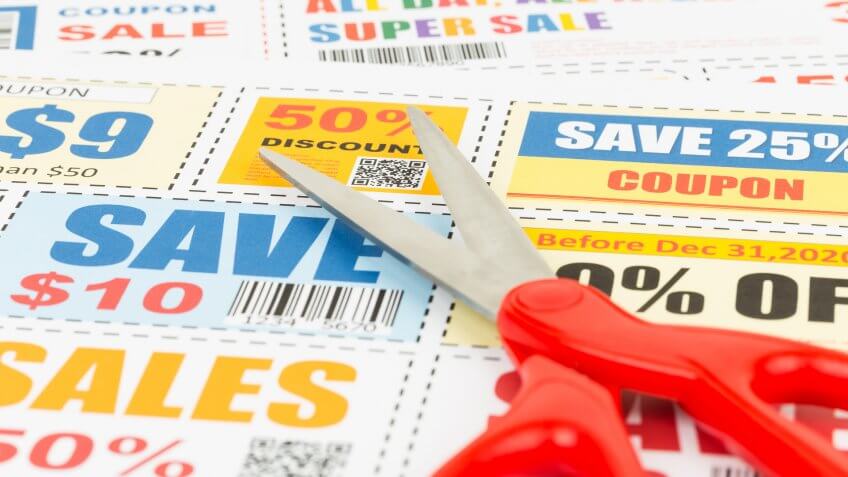 Saving discount coupon voucher with scissors, coupons are mock-up