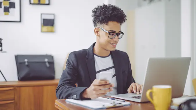 Young man working at home office.