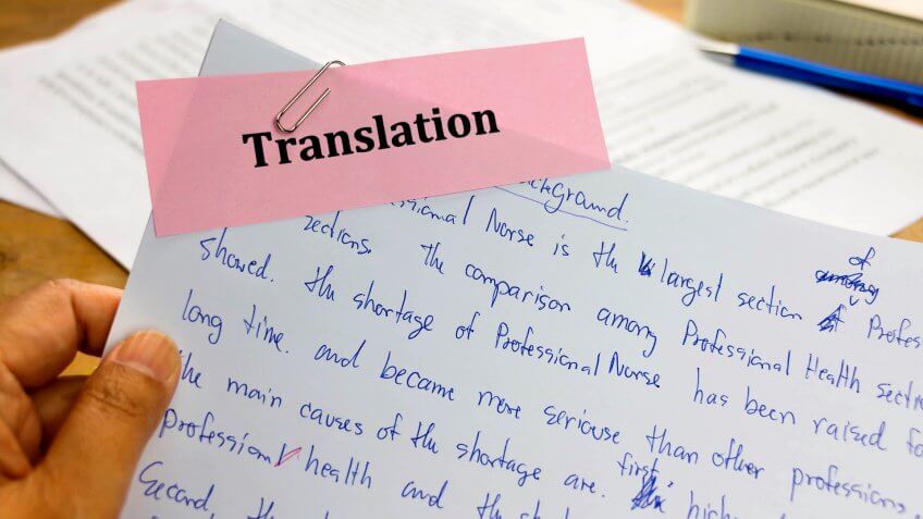handwriting blue english words on white paper represent translating to English language