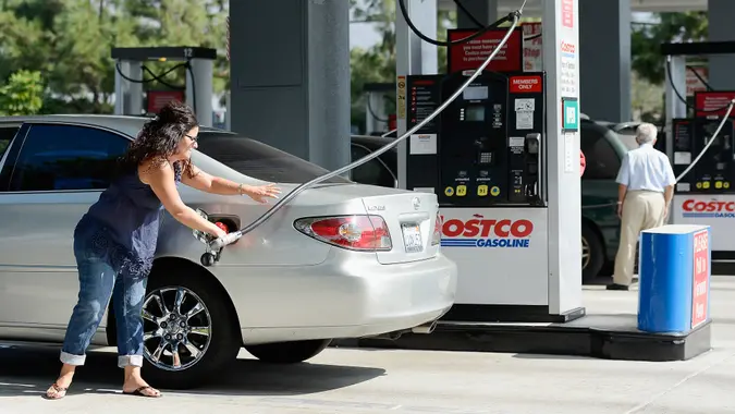 BURBANK, CA - OCTOBER 05:  Customers gas up their car at Costco Wholesale Corp.