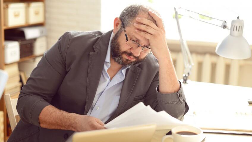 Mature Adult man working in the office.