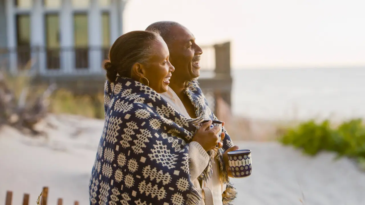 60-65 years, 65-70 years, African Ethnicity, Beach, Blanket, Boyfriend, Coffee, Color Image, Copy Space, Couple, Family, Food And Drink, Girlfriend, Heterosexual Couple, Horizontal, House, Husband, Laughing, Leisure Activity, Love, Mug, Outdoors, Photography, Relaxation, Senior Adult, Side View, Smiling, Standing, Sunrise, Sunset, Travel, Two People, Waist Up, Weekend Activities, Wife, anniversary, babyboomer, cuddling, enjoying, friend, happy, man, men and women, nature, ocean, people, profile, recreation, resort, retirement, romance, together, vacation, woman