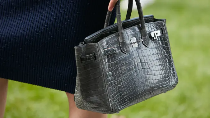 Woman with gray crocodile Hermes.