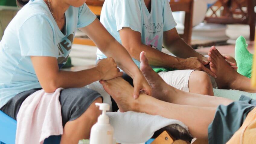 two women were doing traditional massage Thai massage and foot massage.