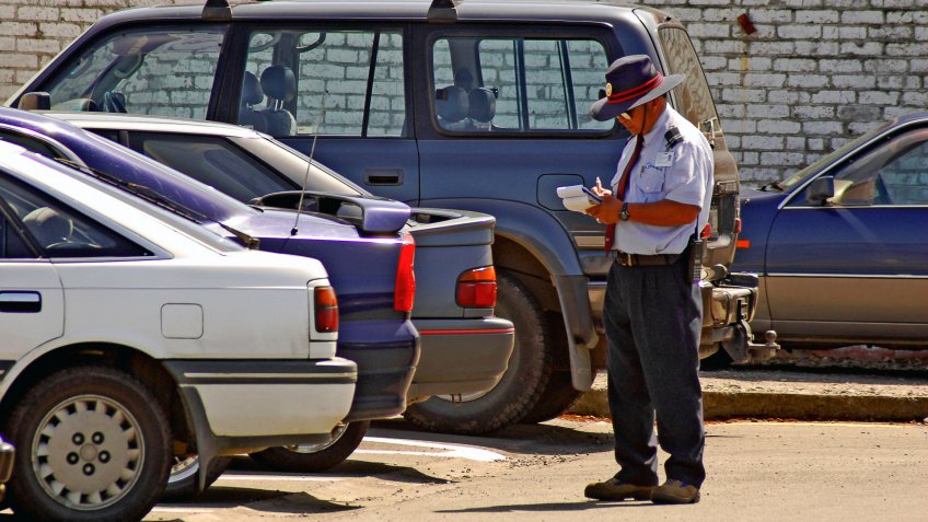 Parking Enforcement giving a ticket.