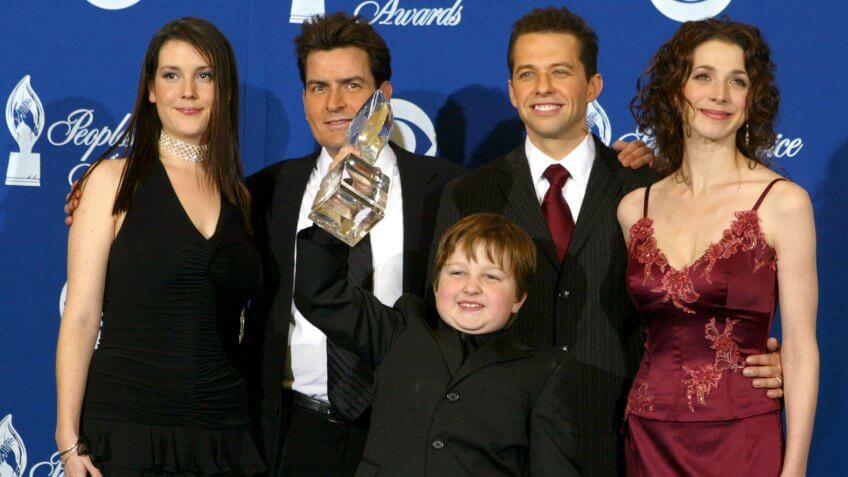 PASADENA, CA - JANUARY 11: Winners of "Favorite New Television Comedy", the cast of "Two and a Half Men", (L-R) Melanie Lynskey, Charlie Sheen, Angus T Jones, Jon Cryer and Marin Hinkle pose backstage during the 30th Annual People's Choice Awards at the Pasadena Civic Auditorium January 11, 2004 in Pasadena, California.