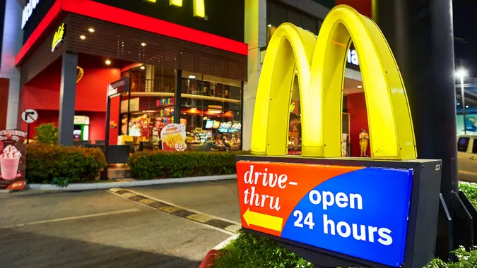 A McDonald's sign near the fast food restaurant in a city area.