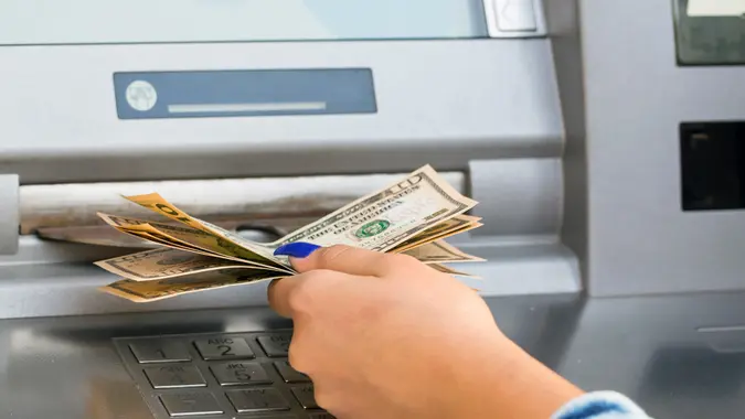 withdrawing money from outdoor bank ATM