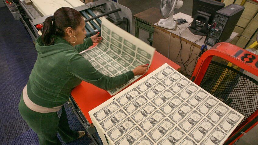 WASHINGTON - MARCH 26: Angela Jones inspects sheets of soon to be one dollar bills before they are cut into singles at the Bureau of Engraving and Printing on March 26, 2009 in Washington, DC.
