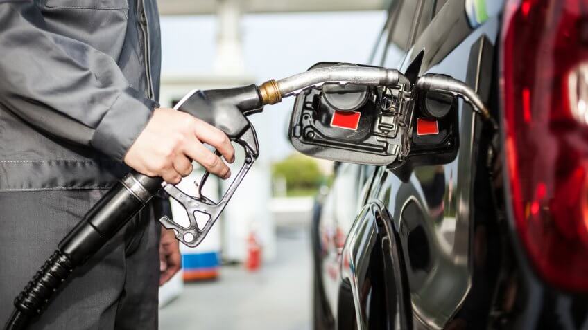 pumping gas at station.