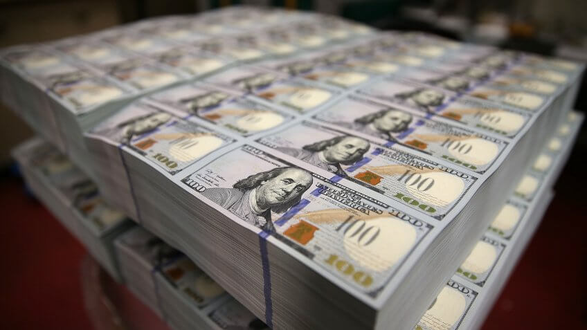 WASHINGTON, DC - MAY 20: Newly redesigned $100 notes lay in stacks at the Bureau of Engraving and Printing on May 20, 2013 in Washington, DC.