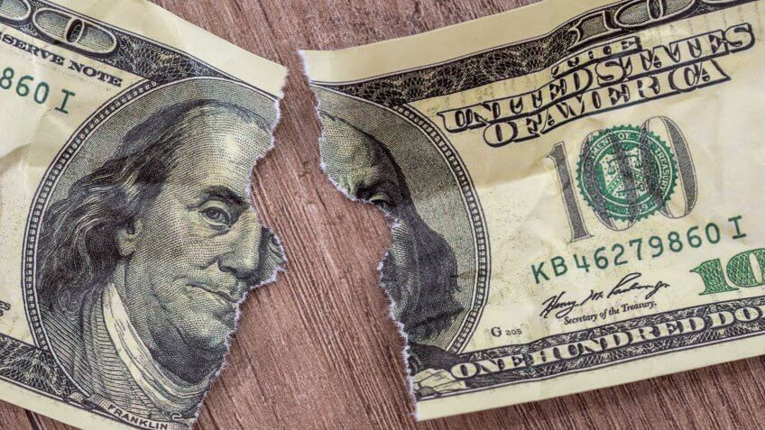 Dollars bill torn as background.